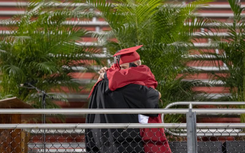 Fort White Principal Keith Couey hugs his son Kameron, one of the graduates, during the Class of 2020 commencement ceremony Friday night. (RAY CARPENTER/Lake City Reporter)