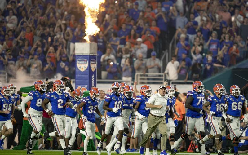 Florida Gators head coach Dan Mullen leads his team onto the field at the Orange Bowl at Hard Rock Stadium on Dec. 30, 2019, in Miami Gardens. (ALLEN EYESTONE/The Palm Beach Post/TNS)