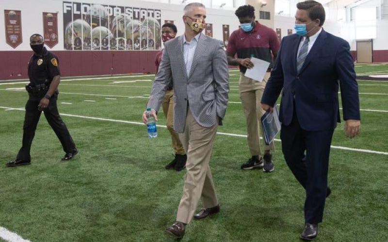 Gov. Ron DeSantis and FSU Head Football Coach Mike Norvell both advocate playing college football this fall. (TORI LYNN SCHNEIDER/Tallahassee Democrat/TNS)