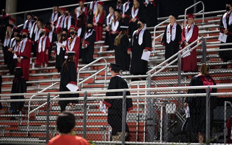 Students file in prior to the start of the graduation ceremony Friday night at Fort White. (RAY CARPENTER/Lake City Reporter)