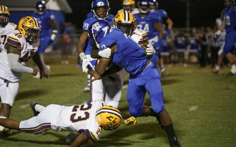 Columbia defensive back Jaden Robinson tackles Trinity Christian running back Treyaun Webb on Friday night. (BRENT KUYKENDALL/Lake City Reporter)