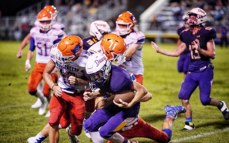 Branford’s Adrik Miller (12) and Clay Williams (11) converge for a tackle against Bell on Sept. 12. (BRIAN LEWIS/Special to the Reporter)