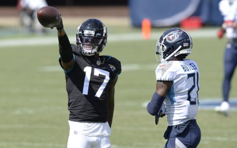 Jacksonville Jaguars wide receiver D.J. Chark (17) signals a first down after a reception against Tennessee Titans cornerback Malcolm Butler (21) on Sunday, in Nashville, Tenn. (MARK ZALESKI/Associated Press)