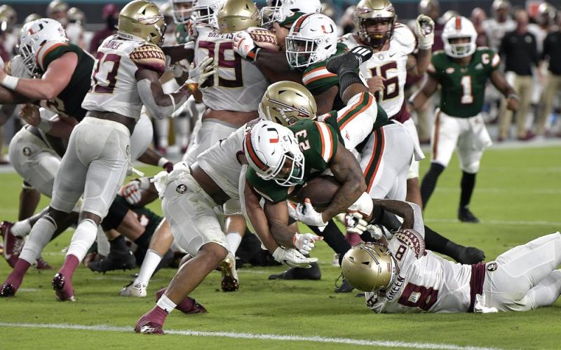 Miami running back Cam'Ron Harris (23) scores a touchdown against Florida State on Saturday, in Miami Gardens. (MICHAEL LAUGHLIN/South Florida Sun-Sentinel via AP)