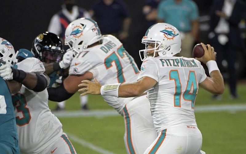 Miami Dolphins quarterback Ryan Fitzpatrick (14) throws a touchdown pass against the Jacksonville Jaguars during the first half Thursday, in Jacksonville. (PHELAN M. EBENHACK/Associated Press)