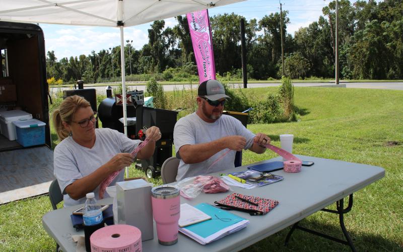 Sherry Wheeler Sheppard (left) and Donnie Feagle (right), Suwannee River Breast Cancer Awareness Association president, sell raffle tickets for the upcoming Suwannee River Breast Cancer Awareness Open Bass Tournament. The tournament will take place this Saturday at Sandy Point boat ramp in Branford. The event’s weigh-in is scheduled for 3 p.m. (TONY BRITT/Lake City Reporter)
