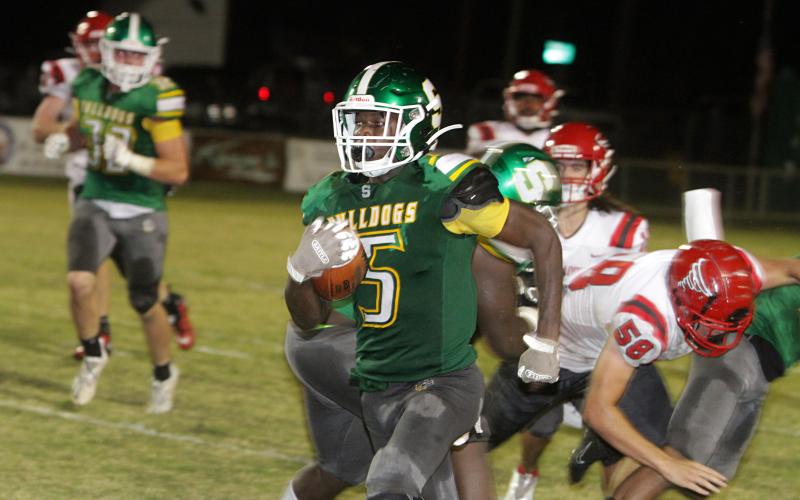 Suwannee defensive back Terrell Atkinson races down the sideline on an interception return for a touchdown on the final play of the first half Friday night against Bradford at Langford Stadium. (PAUL BUCHANAN/Special to the Reporter)