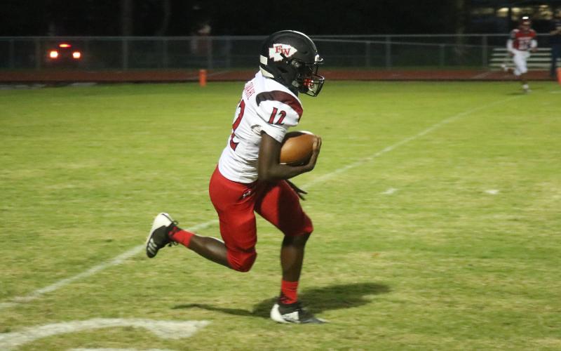 Fort White defensive back Najeeb Smith returns an interception against Santa Fe on Friday night. Smith also caught four passes for 113 yards while playing receiver. (JORDAN KROEGER/Lake City Reporter)