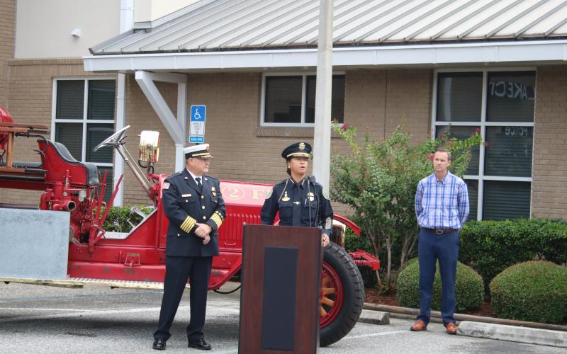 Randy Burnham (from left), Lake City fire chief, looks on as Argatha Gilmore, Lake City police chief, addresses the audience during Friday’s 9/11 ceremony at the Lake City Public Safety building while Jay Swisher, Columbia County Clerk of Courts, listens intently. (TONY BRITT/Lake City Reporter)