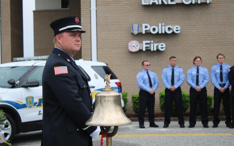 Daniel Dorn, a Lake City Fire Department driver/engineer, stands near a bell that was rung in honor of 9/11 terrorist attack victims Friday morning. (TONY BRITT/Lake City Reporter)