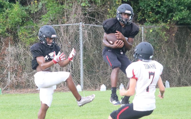 Fort White defensive back Gene Smith intercepts a pass during Wednesday’s practice. (JORDAN KROEGER/Lake City Reporter)