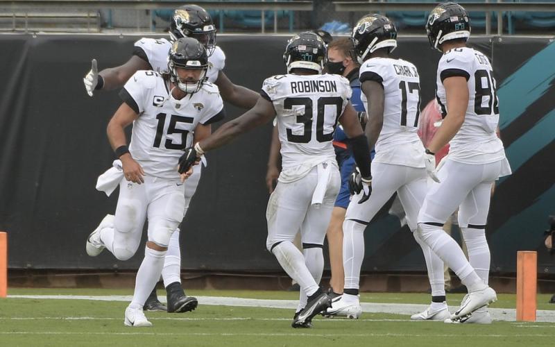 Jacksonville Jaguars quarterback Gardner Minshew (15) celebrates after throwing a touchdown pass to wide receiver D.J. Chark (17) during the first half of an NFL football game against the Indianapolis Colts on Sunday, in Jacksonville. (AP PHOTO)