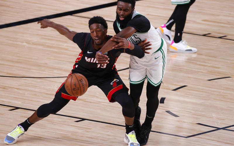 Boston Celtics forward Jaylen Brown (7) and Miami Heat center Bam Adebayo (13)  fight for a loose ball during the fourth quarter in Game 6 of the Eastern Conference finals at AdventHealth Arena at the ESPN Wide World Of Sports Complex on Sunday, in Lake Buena Vista. (KEVIN C. COX/Getty Images/TNS)