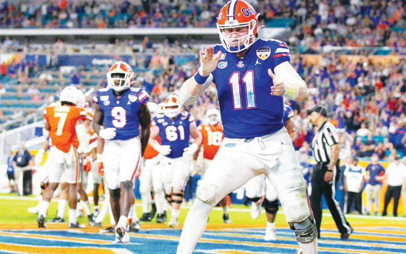 Florida Gators quarterback Kyle Trask (11) reacts after scoring on a two-point conversion late in the fourth quarter against the Virginia Cavaliers during the Capital One Orange Bowl at Hard Rock Stadium on Dec. 30, 2019, in Miami. (AL DIAZ/Miami Herald/TNS)