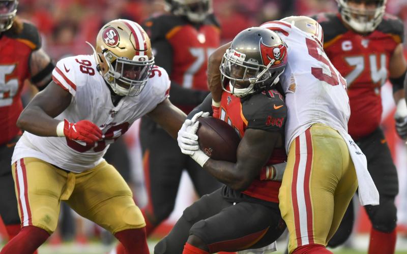 Tampa Bay Buccaneers running back Dare Ogunbowale (44) is tackled by San Francisco 49ers middle linebacker Fred Warner (54) in the fourth quarter on Sunday, Sept. 8, 2019 at Raymond James Stadium in Tampa. (ALLIE GOULDING/Tampa Bay Times/TNS)