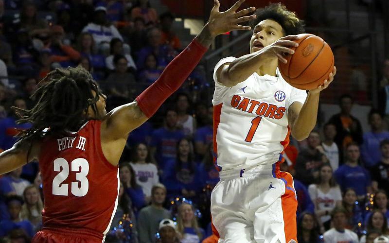 Florida guard Trey Mann goes for a shot around Alabama’s John Petty Jr. (23) last season at the O’Connell Center. (TRIBUNE NEWS SERVICE)