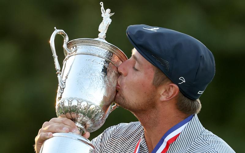 Bryson DeChambeau kisses the championship trophy in celebration after winning the 120th U.S. Open Championship on Sunday at Winged Foot Golf Club in Mamaroneck, NY. (GREGORY SHAMUS/Getty Images/TNS)