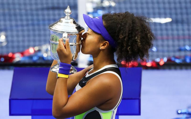Naomi Osaka kisses the trophy in celebration after winning her Women's Singles final match against Victoria Azarenka of Belarus on Day thirteen of the 2020 U.S. Open at the USTA Billie Jean King National Tennis Center on Saturday in the Queens borough of New York City. (MATTHEW STOCKMAN/Getty Images/TNS)