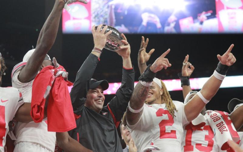 Ohio State coach Ryan Day holds up the trophy after their 34-21 come from behind win over Wisconsin at the Big Ten Championship Game at Lucas Oil Field on Dec. 7 2019, in Indianapolis. (DAVID PETKIEWICZ/cleveland.com/TNS)