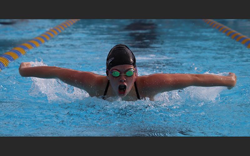 Columbia swimmer Kaydence Clark competes in the 100-yard butterfly during Wednesday’s tri-meet against Saint Francis Catholic and Oak Hall. (SHELBY CONKLIN/Special to the Reporter)