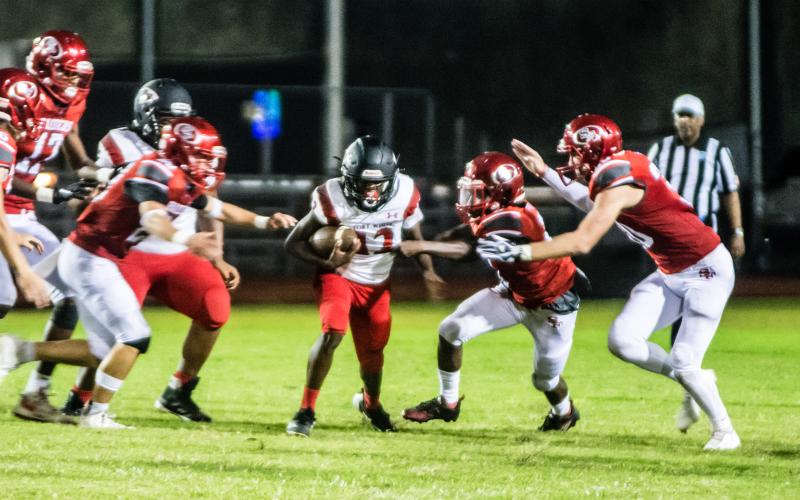Fort White receiver Najeeb Smith is surrounded by Santa Fe defenders last week. (CHRISTINA FEAGIN/Special to the Reporter)