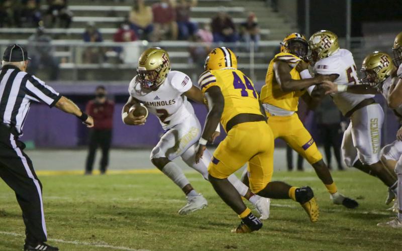 BRENT KUYKENDALL/Lake City Reporter Florida High quarterback Tre Donaldson scrambles up the field as Columbia linebacker Bobby Miller gives chase on Friday. (BRENT KUYKENDALL/Lake City Reporter)