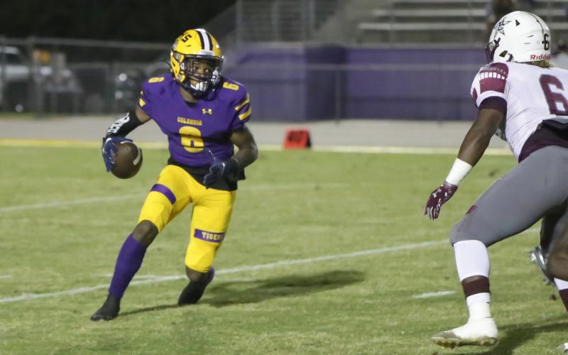 Columbia receiver Tray Tolliver scrambles out of the wildcat package against Madison County last Friday. (BRENT KUYKENDALL/Lake City Reporter)