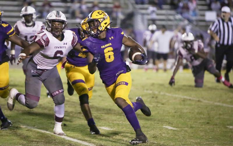 Columbia receiver Tray Tolliver runs it up the field out of the read option against Madison County on Friday night. (BRENT KUYKENDALL/Lake City Reporter)
