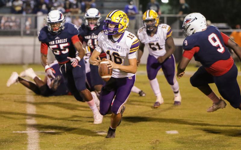Columbia quarterback Bronsen Tillotson rolls out to pass last Friday against Wakulla. (BRENT KUYKENDALL/Lake City Reporter)