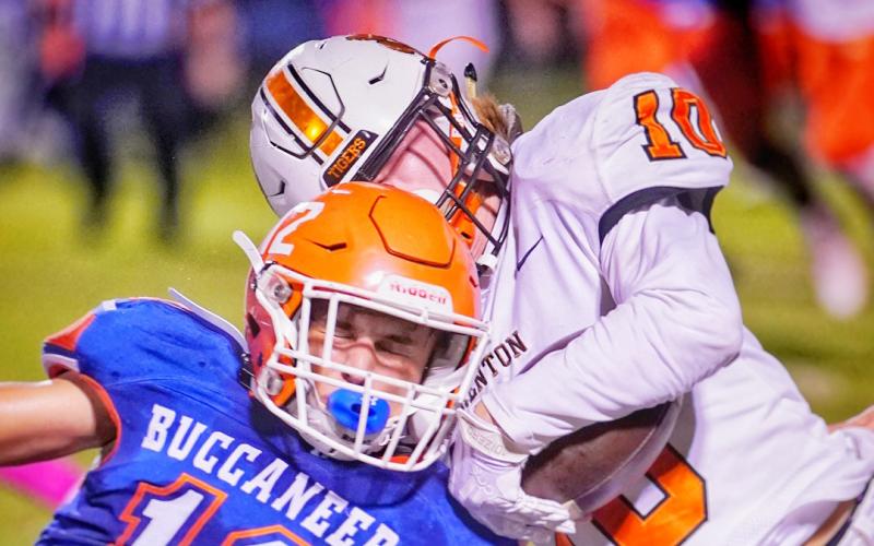 Branford’s Adrik Miller delivers a hit against Trenton’s Caleb Morgan on Friday night. (BRIAN LEWIS/Special to the Reporter)