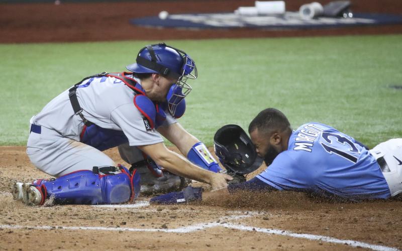 Los Angeles Dodgers catcher Austin Barnes (15) places the tag on Tampa Bay Rays left fielder Manuel Margot as Margot attempted to steal home plate during the fourth inning in Game 5 of the World Series between the Tampa Bay Rays and the Los Angeles Dodgers on Sunday in Arlington, TX. (TRIBUNE NEWS SERVICE)