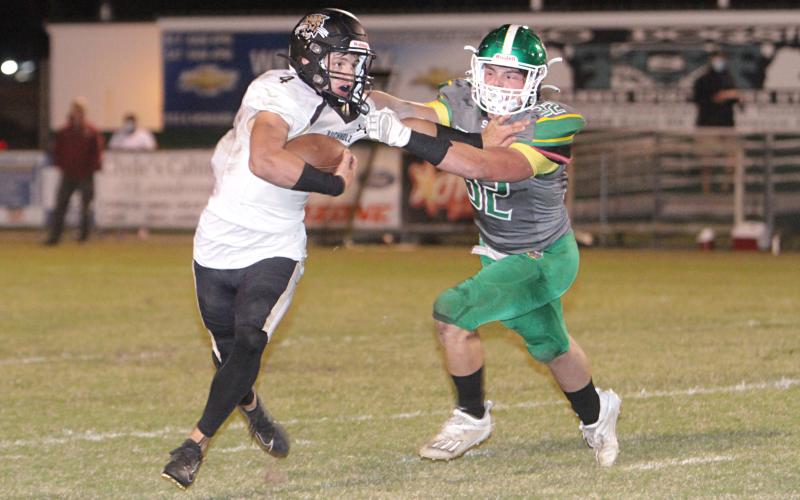 Suwannee linebacker Blaine Howard tries to tackle Buchholz receiver Creed Whittemore last Friday. (PAUL BUCHANAN/Special to the Reporter)