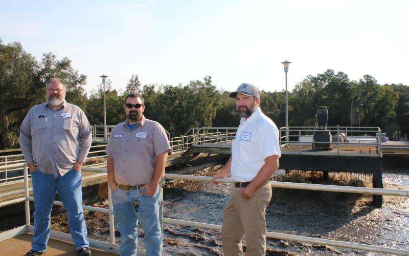 Bill Fish (from left), Tyler Todd and Cody Pridgeon stand atop a monitoring area for the aeration basin tanks at the St. Margarets Wastewater Treatment Facility on Friday morning. The aeration basin tanks  will be upgraded as part of a $6.1 million project at the facility. (TONY BRITT/Lake City Reporter)