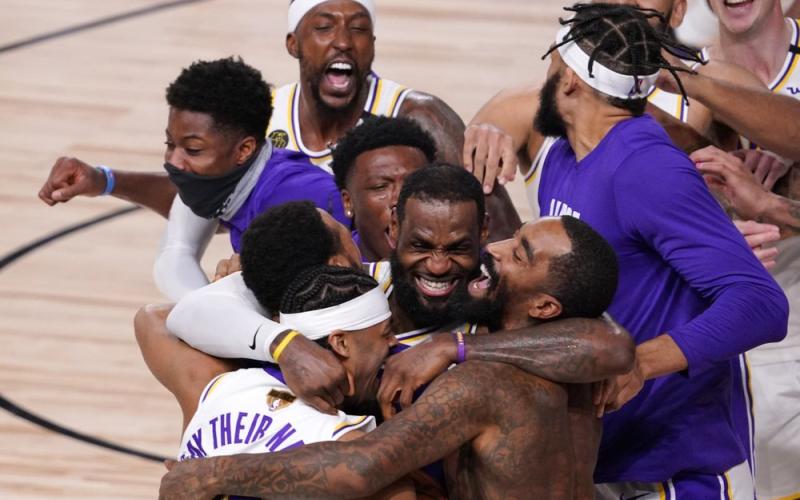 Los Angeles Lakers' LeBron James (23) celebrates with his teammates after the Lakers defeated the Miami Heat 106-93 in Game 6 of the NBA Finals on Sunday in Lake Buena Vista. (MARK J. TERRILL/Associated Press)