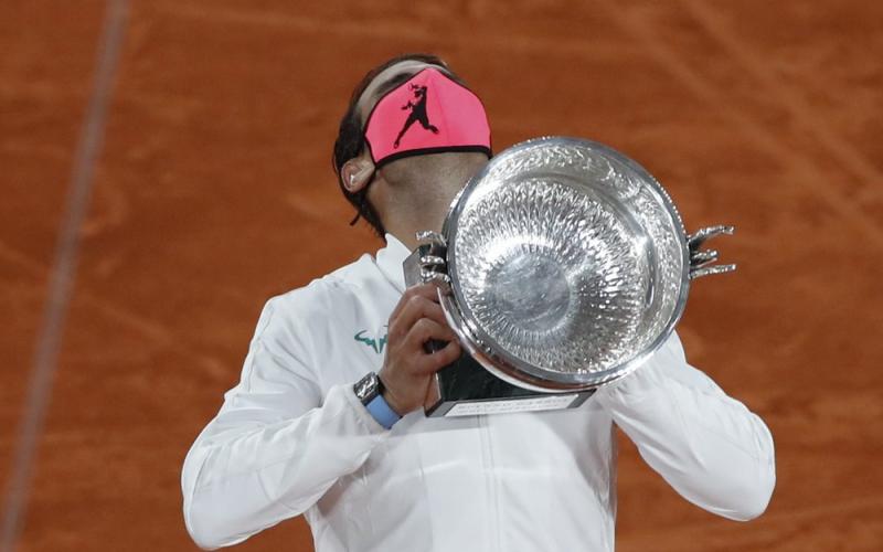 Rafael Nadal holds the trophy as he celebrates winning the final match of the French Open against Novak Djokovic in three sets, 6-0, 6-2, 7-5, at the Roland Garros stadium on Sunday in Paris, France. (ALESSANDRA TARATINO/Associated Press)