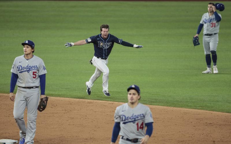 The Tampa Bay Rays' Brett Phillips celebrates his game-winning two-run single against the Los Angels Dodgers in Game 4 of the World Series at Globe Life Field on Saturday in Arlington, Texas. The Rays won 8-7 to even the series. (ROBERT GAUTHIER/Los Angeles Times/TNS)