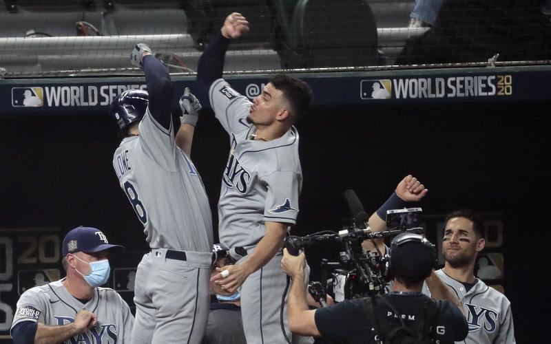 The Tampa Bay Rays' Brandon Lowe, top left, celebrates his first-inning solo home run with teammate Willy Adames in Game 2 of the World Series at Globe Life Field on Wednesday in Arlington, Texas. (ROBERT GAUTHIER/Los Angeles Times/TNS)