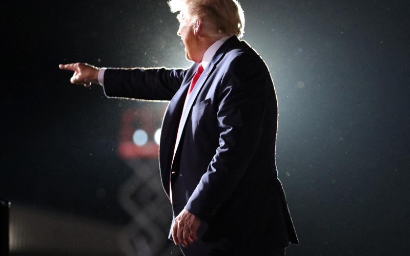 President Donald Trump waves goodbye to cheering supporters as he departs his campaign rally at Orlando Sanford International Airport in Sanford, Fla., on Monday. (JOE BURBANK/Orlando Sentinel/TNS)