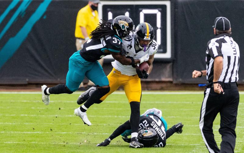 Jacksonville Jaguars cornerback Tre Herndon (37) makes the tackle on Pittsburgh Steelers running back James Conner (30) at TIAA Bank Field last Sunday in Jacksonville. (MATT PENDLETON/TNS)