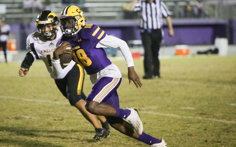 Columbia quarterback Marcus Peterson speeds past an Englewood defender during Friday’s Region 1-6A play-in playoff game. (BRENT KUYKENDALL/Lake City Reporter)