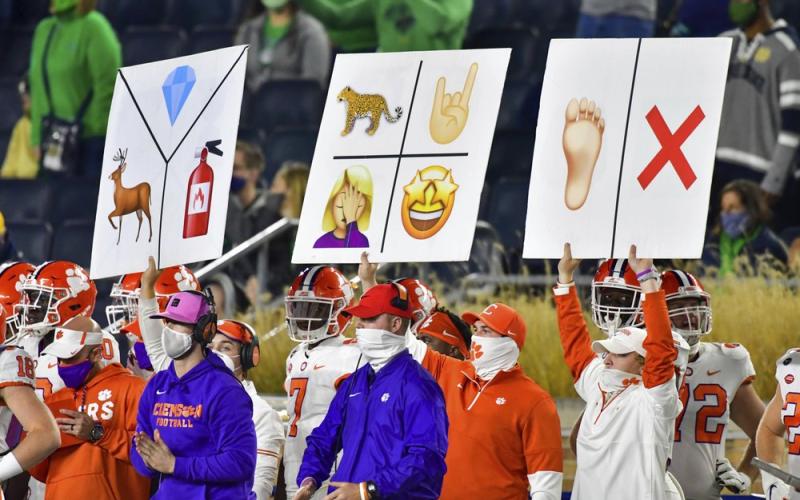 Clemson sideline personnel hold play signal cards during the third quarter of the team's game against Notre Dame on Nov. 7 in South Bend, Ind. (MATT CASHORE/AP Pool Photo)