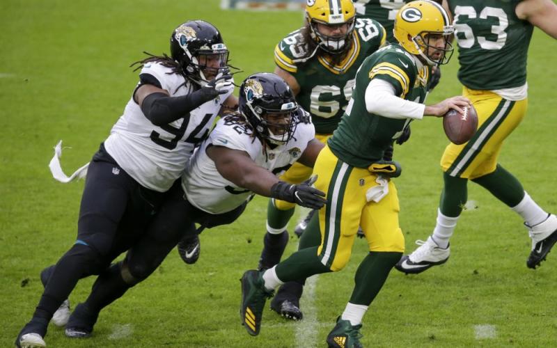 Green Bay Packers' Aaron Rodgers scrambles against the Jacksonville Jaguars Sunday in Green Bay, Wis. (MIKE ROEMER/Associated Press)