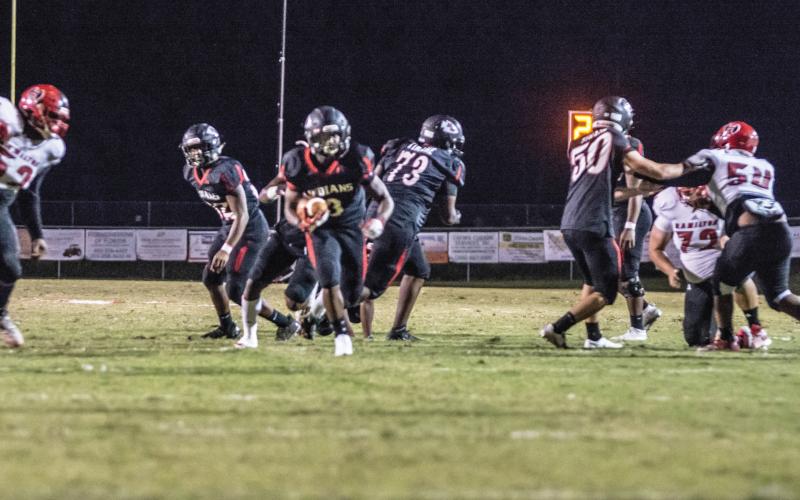 Fort White running back Tavion Taylor hits the hole on a carry up the middle against Hamilton County last Friday. (CHRISTINA FEAGIN/Special to the Reporter)