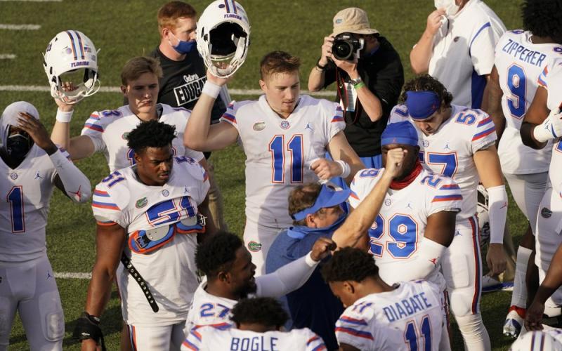 Florida quarterback Kyle Trask (11) joins head coach Dan Mullen, center, in singing their school song after a game against Vanderbilt on Nov. 21 in Nashville, Tenn. Florida won 38-17. (MARK HUMPHREY/Associated Press)