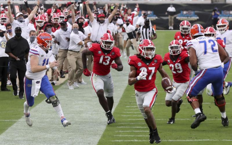 Georgia defensive back Eric Stokes (27) returns an interception for a touchdown against Florida on Saturday in Jacksonville. (CURTIS COMPTON Compton/Atlanta Journal-Constitution via AP)