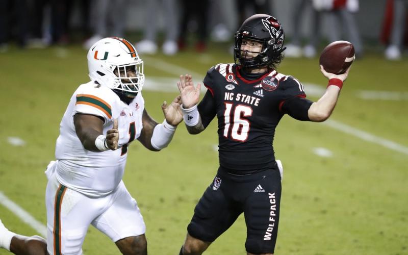 North Carolina State quarterback Bailey Hockman (16) prepares to pass while pressured by Miami defensive lineman Nesta Jade Silvera (1) on Nov. 6 in Raleigh, N.C. (ETHAN HYMAN/The News &amp; Observer via AP, Pool)