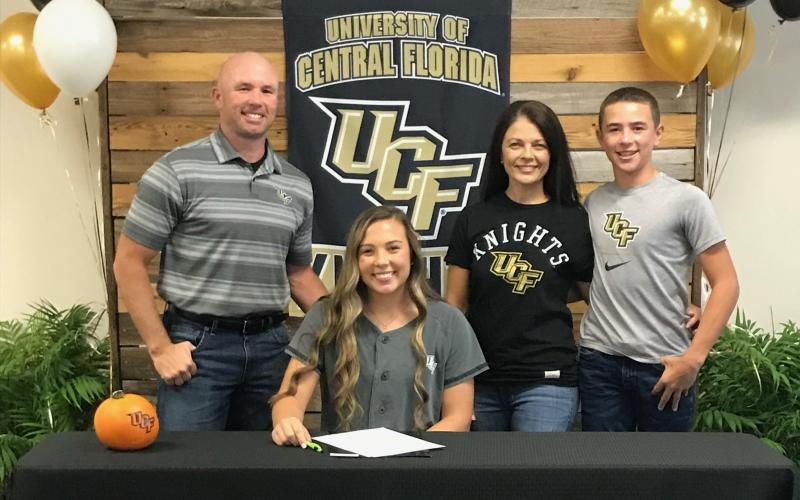 Suwannee catcher Carson Frier is pictured with her father, Todd (left), mother, Carmon (middle right) and brother Koy (far right) after signing her letter of intent with UCF on Wednesday. (COURTESY)