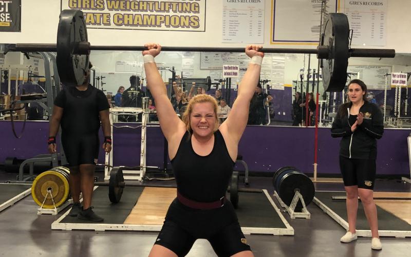 Columbia’s Reece Chasteen finishes her clean and jerk during Tuesday’s meet against Fort White. She won the 183-pound weight class. (JEN CHASTEEN/Special to the Reporter)