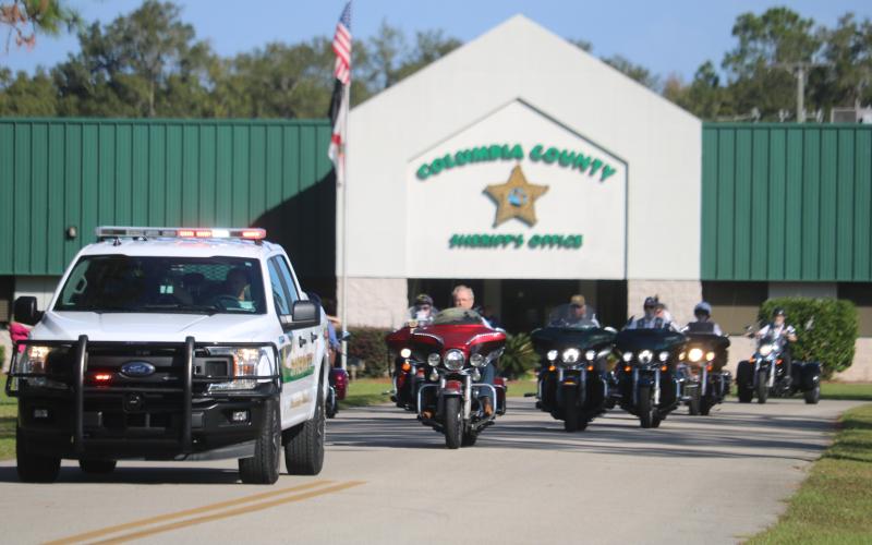 Bill Huggins, American Legion Riders Director, and other Legion Riders follow deputies as they escort the Vietnam Traveling Memorial Wall from the sheriff’s office Thursday morning. (TONY BRITT/Lake City Reporter)