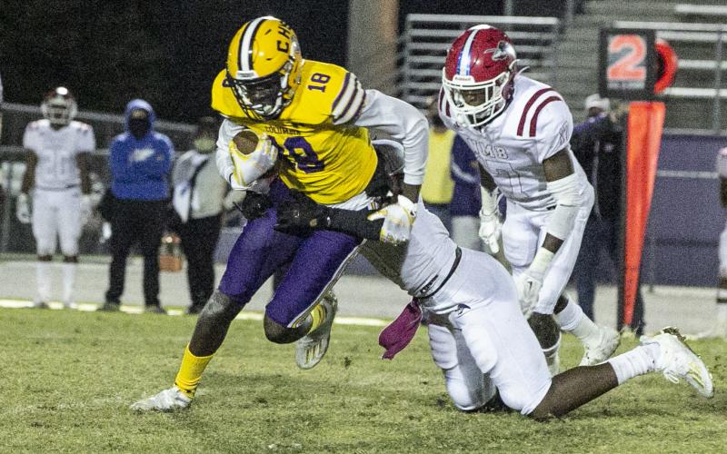Columbia receiver Marcus Peterson tries to escape a tackle against North Miami Beach last Friday. (JEN CHASTEEN/Special to the Reporter)